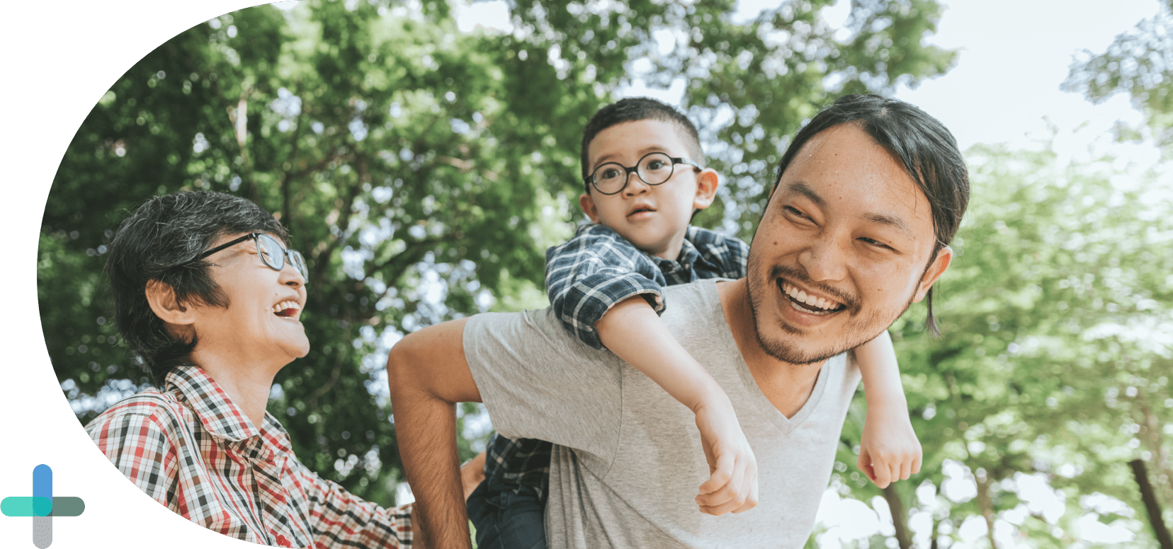 man and woman smiling with child on man's back