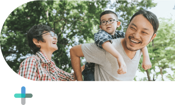 man and woman smiling with child on man's back