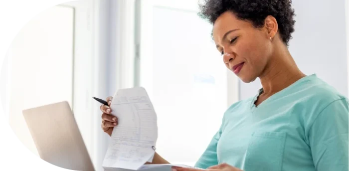 woman holding and reading paper with notes