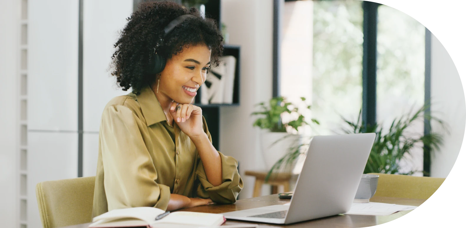 woman wearing headphones and using laptop