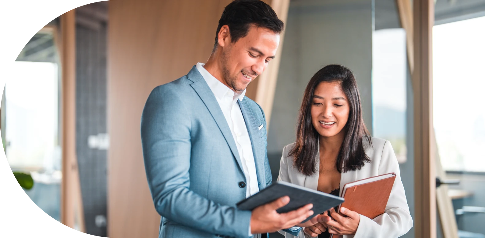 man and woman standing together with man holding tablet