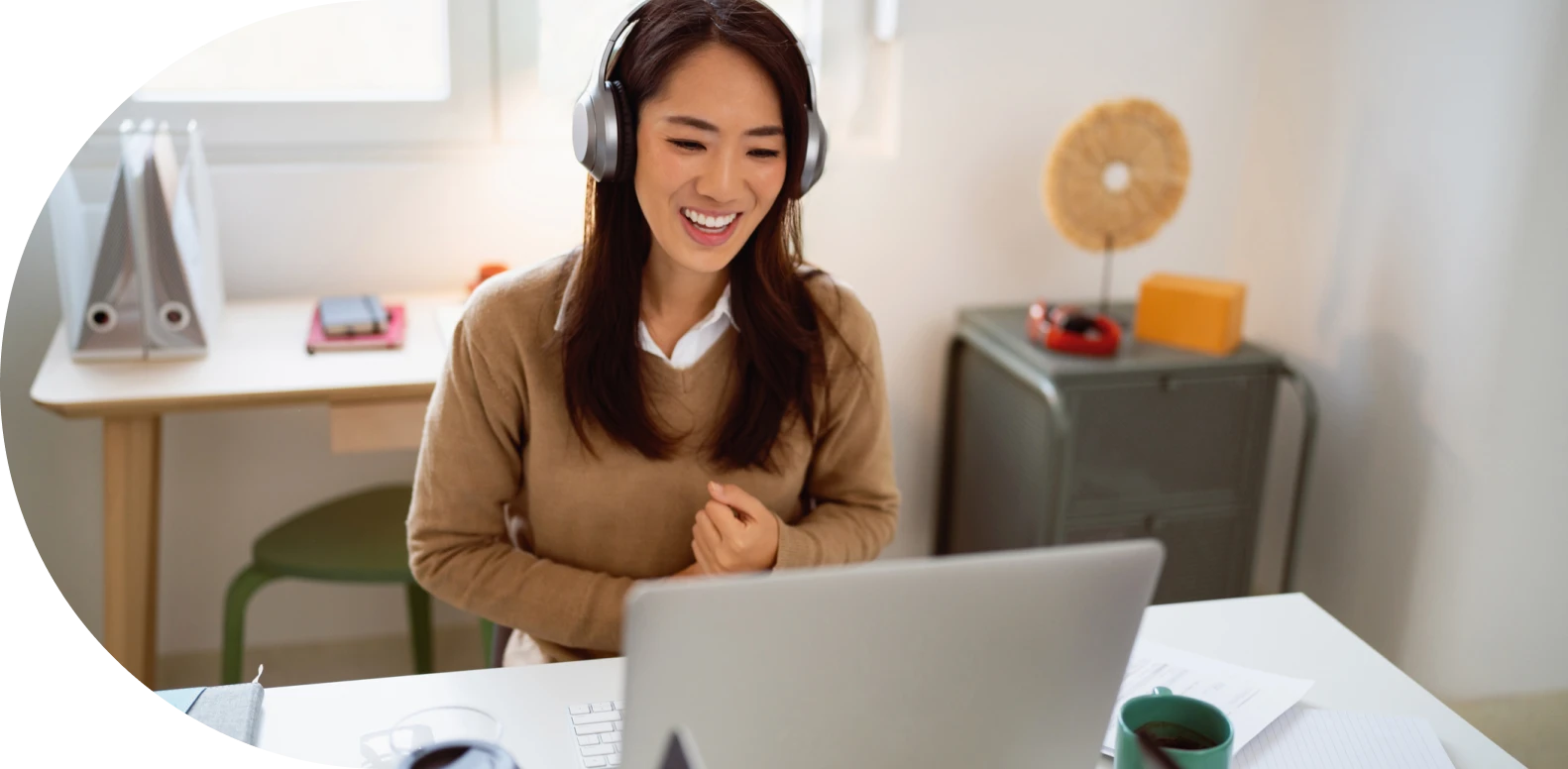 woman wearing headphones and using laptop