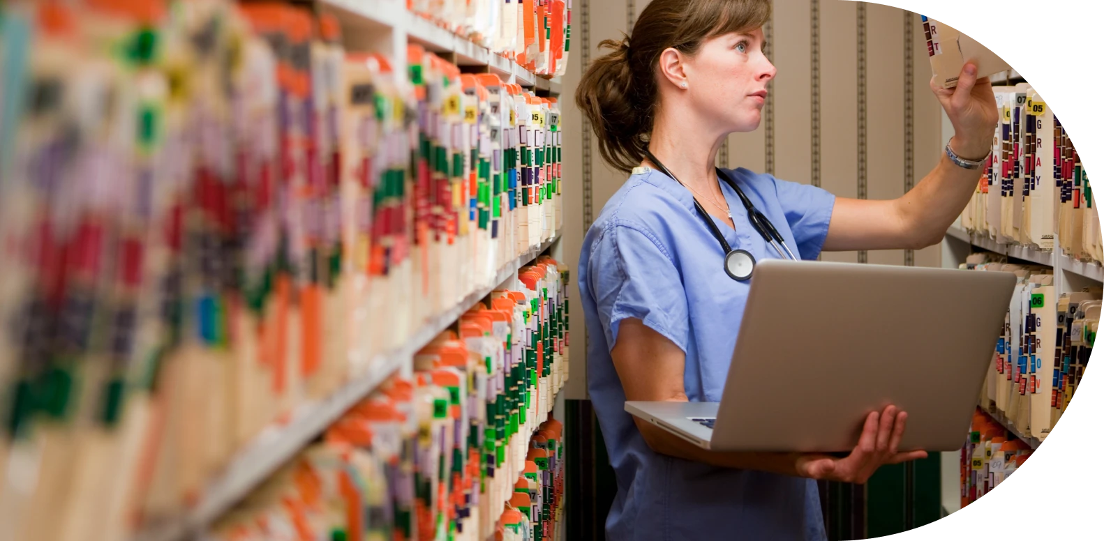 female nurse holding laptop and searching documents